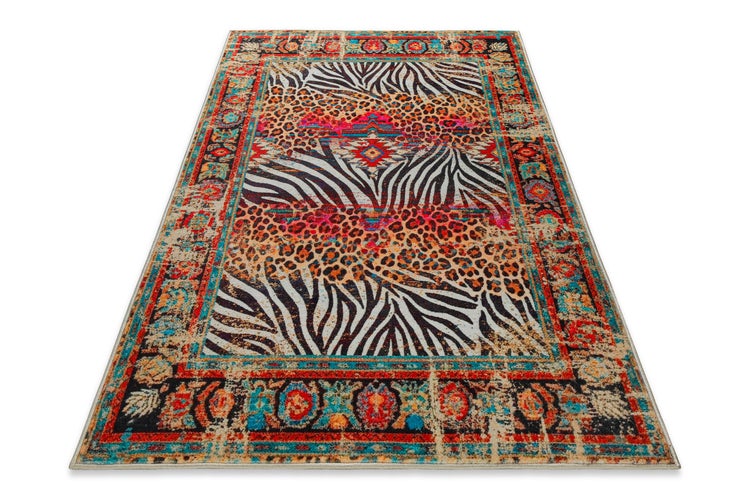 Rechteckiger Teppich mit Patchwork-Muster aus Tierprints wie Zebra und Leopard sowie einer gemusterten Bordüre im Vintage-Stil.