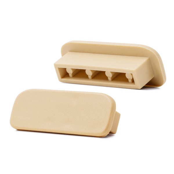 Abdeckkappe aus Kunststoff in Beige, rechteckig mit abgerundeten Ecken.