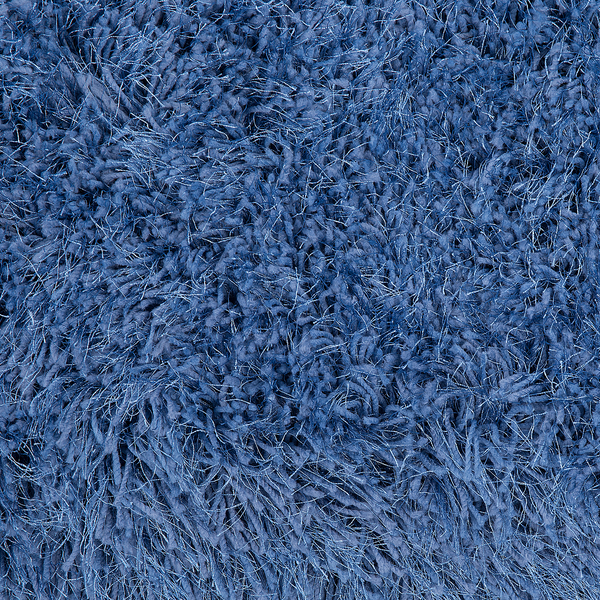 Nahaufnahme eines blauen Hochflor Teppichs mit weichen, langen Fasern.
