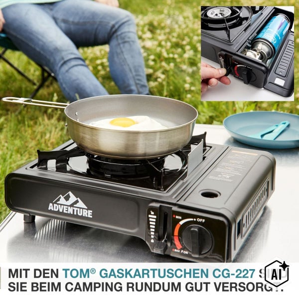Adventure Gaskocher mit Gaskartusche beim Braten eines Spiegeleis auf einem Campingtisch im Freien.