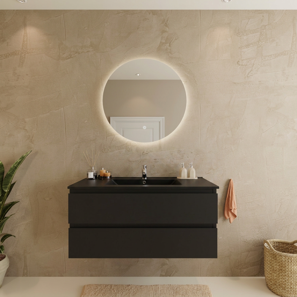 Badezimmer mit schwarzem Wand-Waschtischunterschrank, zwei Schubladen, integriertem Waschbecken, rundem beleuchtetem Spiegel und strukturierter Wand.
