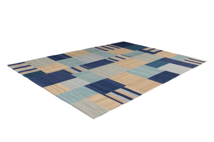 Flachgewebter Teppich mit modernem geometrischem Patchwork-Muster in Blau, Beige und Grau.