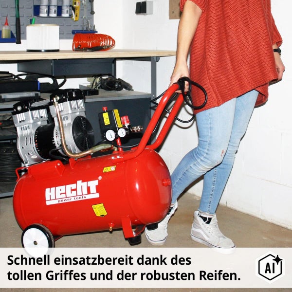 Eine Person zieht einen Hecht Kompressor mit Fahrwerk und Griff in einer Werkstatt.