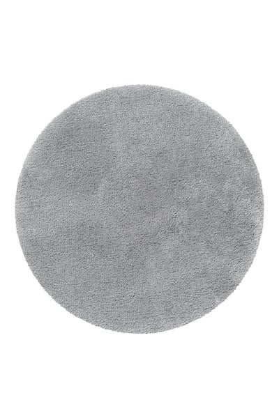 Runder grauer Hochflor-Teppich.