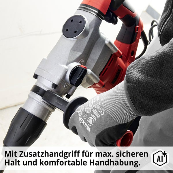 Ein elektrischer Meißelhammer mit Zusatzhandgriff in der Hand eines Arbeiters.