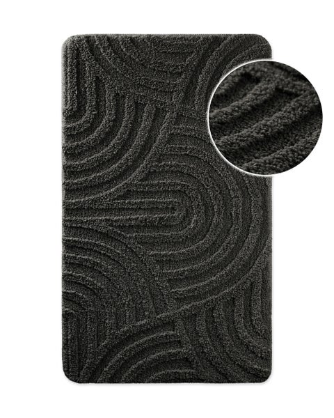 Strukturierte Badematte in Anthrazit mit einem geschwungenen Muster aus weichem Material.