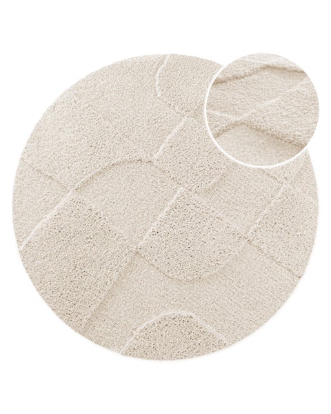 Runder Teppich mit geometrischer Relief-Struktur und weichem Flor.