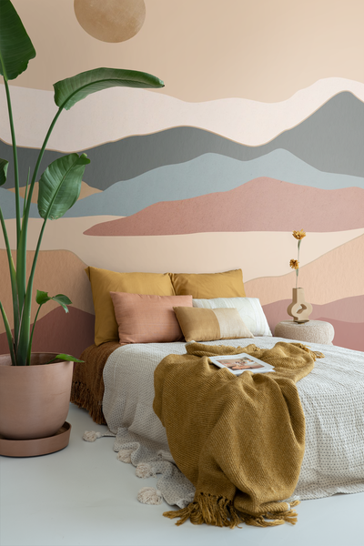 Schlafzimmer mit Bett, Kissen, Decke, Zimmerpflanze und dekorativer Wandgestaltung