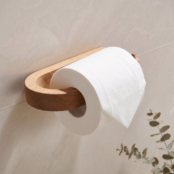 Toilettenpapierhalter aus Holz montiert an einer Fliesenwand mit einer Rolle Toilettenpapier