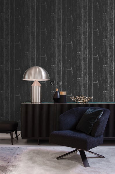 Wohnzimmer mit dunkler Holzoptik-Tapete, Sessel und Kommode