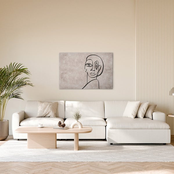 Wohnzimmer mit Sofa, Tisch und Wandbild mit abstrakter Darstellung.