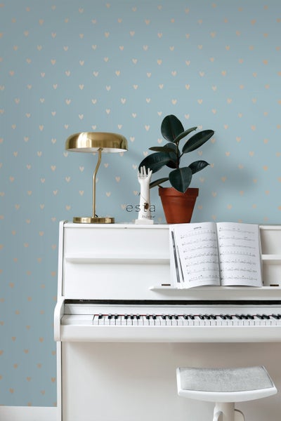 Szene mit weißem Klavier, Lampe, Zimmerpflanze und Tapete mit Herzmuster