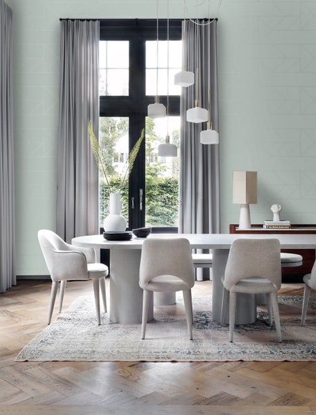 Esszimmer mit Esstisch, Stühlen, Pendelleuchten und Dekoration in einem hellen Raum