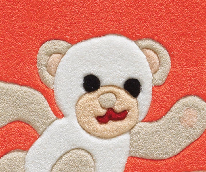 Kinderteppich mit Teddybär-Motiv und strukturierter Oberfläche.