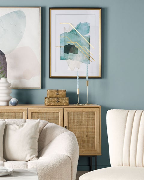 Wohnzimmer mit Kommode, Dekorationsartikeln und Sitzmöbeln