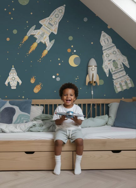 Kinderzimmer mit Weltraum-Tapete, Raketen, Planeten und Sternen hinter einem hellen Holzbett.