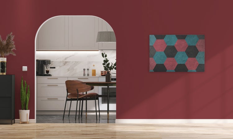 Moderne Küche hinter einem Rundbogen mit angrenzendem Wohnraum mit Wandbild, gestaltet in einem eleganten und zeitgenössischen Einrichtungsstil.