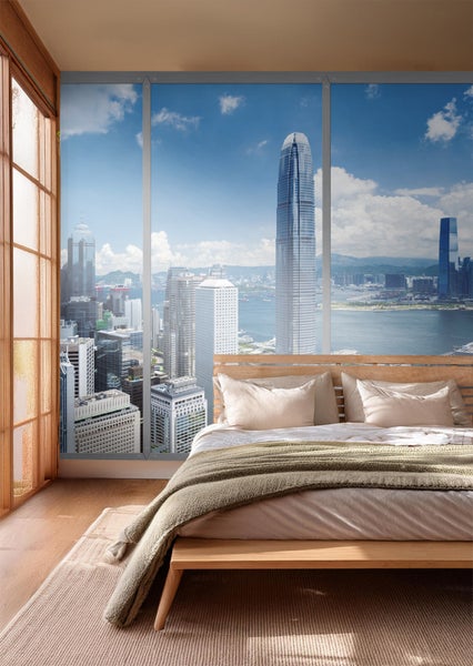 Wandbild im Schlafzimmer mit Skyline-Motiv hinter einem Bett