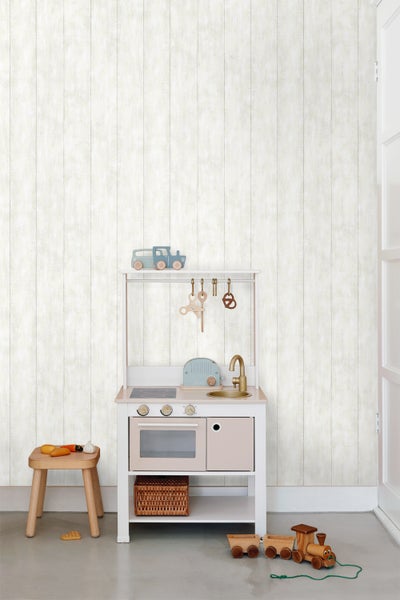 Kinderzimmer mit Spielküche, Hocker und Holzspielzeug vor einer Tapete mit Holzplankenoptik