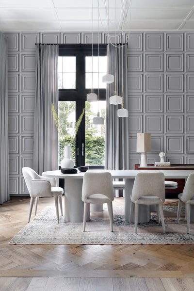 Helles Esszimmer mit Esstisch, Stühlen, Pendelleuchten und dekorativer Wandverkleidung