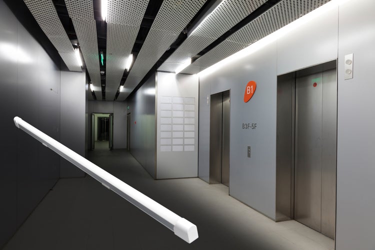 Helle Bürobeleuchtung vor dem Hintergrund eines modernen Korridors mit Aufzügen
