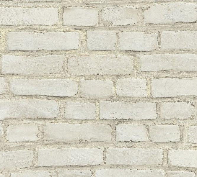 Schreibtisch mit Lampe und Stuhl vor einer Ziegelwand