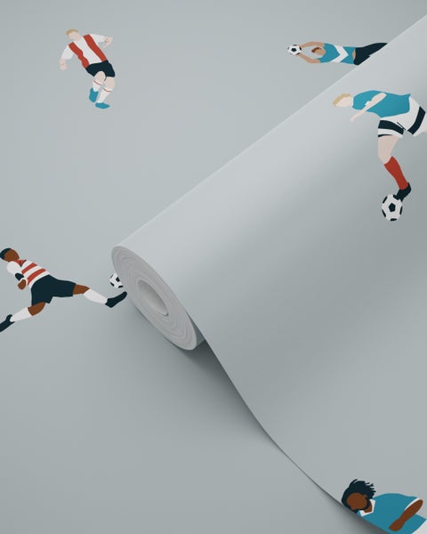 Schlafzimmer mit Bett vor einer Tapete mit Fußballmotiven