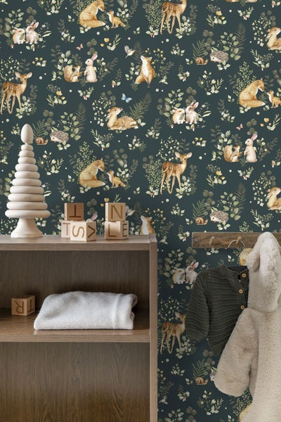 Vliestapete mit Waldtieren wie Fuchs, Reh, Hase und Igel sowie Pflanzenmotiven in einem Kinderzimmer mit Regal aus Holz.