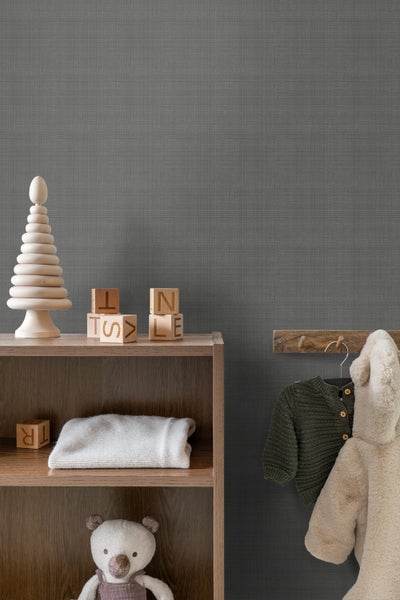 Szene eines Kinderzimmers mit Holzregal, Spielsachen und Kleidung an der Wand