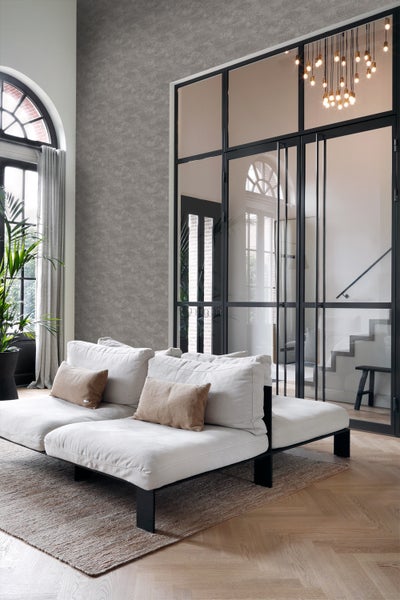 Wohnzimmer mit Sofa, Teppich und Glastür