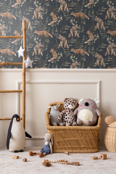 Dekoriertes Kinderzimmer mit dunkler Tapete, Holzleiter und Stofftieren in einem Korb.