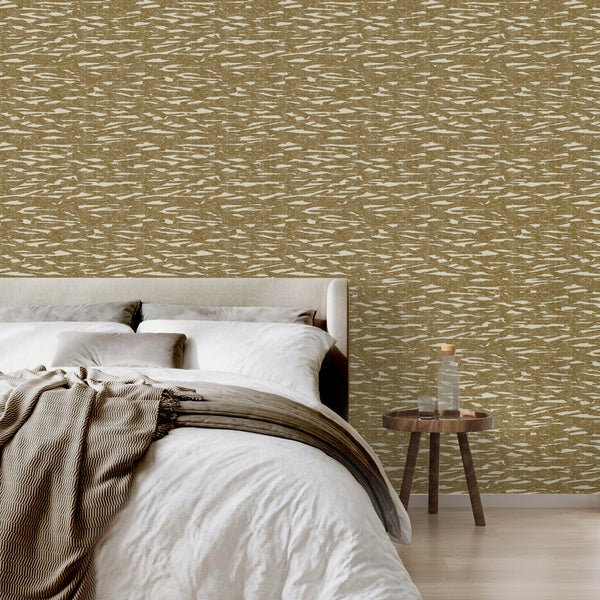 Schlafzimmer mit gemusterter Vliestapete in abstrakter Optik, modernem Bett und rundem Beistelltisch aus Holz.