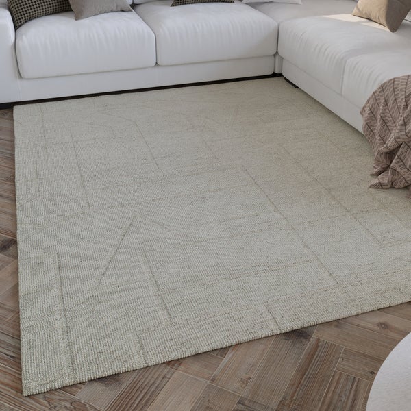 Strukturierter Teppich mit dezentem geometrischem Linienmuster in einem hellen Wohnzimmer vor einem Sofa auf Parkettboden.