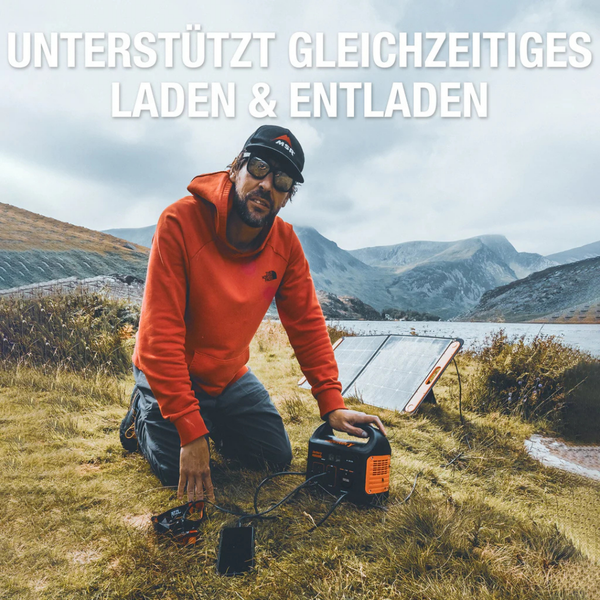 Mann mit Solarmodul und Powerstation im Freien; unterstützt gleichzeitiges Laden und Entladen