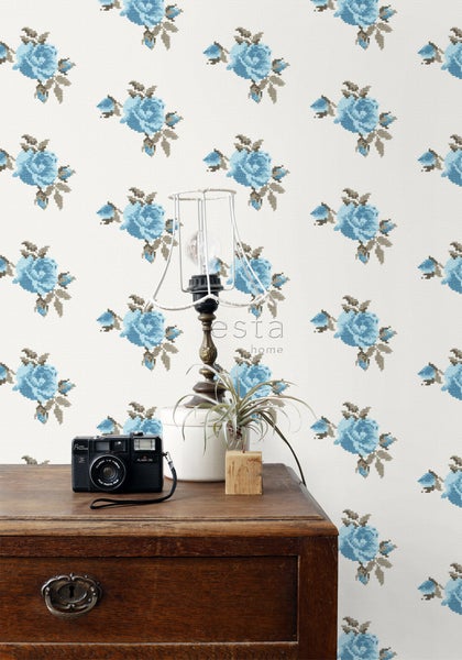 Dekorative Szene mit geblümter Tapete, Tischlampe und Kamera auf einer Kommode