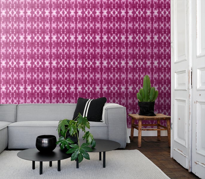 Wohnzimmer mit grauer Couch, Couchtisch und gemusterter Tapete