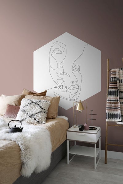 Schlafzimmer mit Bett, Nachttisch, Leiter und Wanddekoration mit Gesichtslinienzeichnung