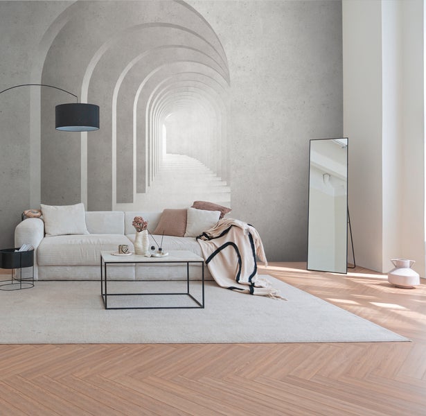 Modernes Wohnzimmer mit einer Fototapete, die einen dreidimensionalen Bogentunnel in Betonoptik darstellt.