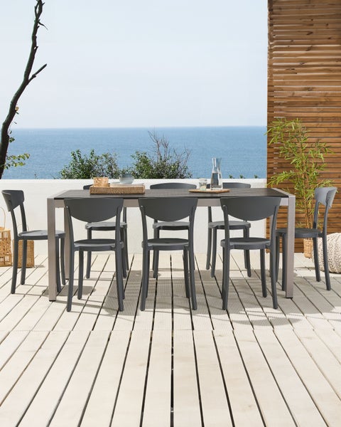 Esstisch mit sechs Stühlen auf einer Terrasse mit Meerblick