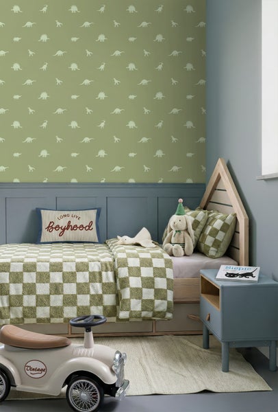 Kinderzimmer mit Dinosaurier-Tapete, einem Hausbett aus Holz, karierter Bettwäsche und einer blau-grauen Wandvertäfelung.