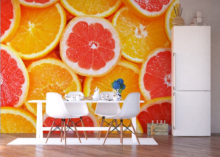Heller Essbereich mit Tisch, Stühlen, Kühlschrank und einer Fototapete mit Orangen und Grapefruits.