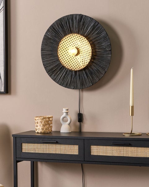 Dekorative Szene mit einer Wandleuchte, einem Konsolentisch und Dekorationsgegenständen.