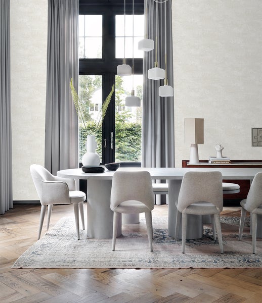 Esszimmer mit Esstisch, Stühlen, Teppich und Dekoration in einem hellen Raum