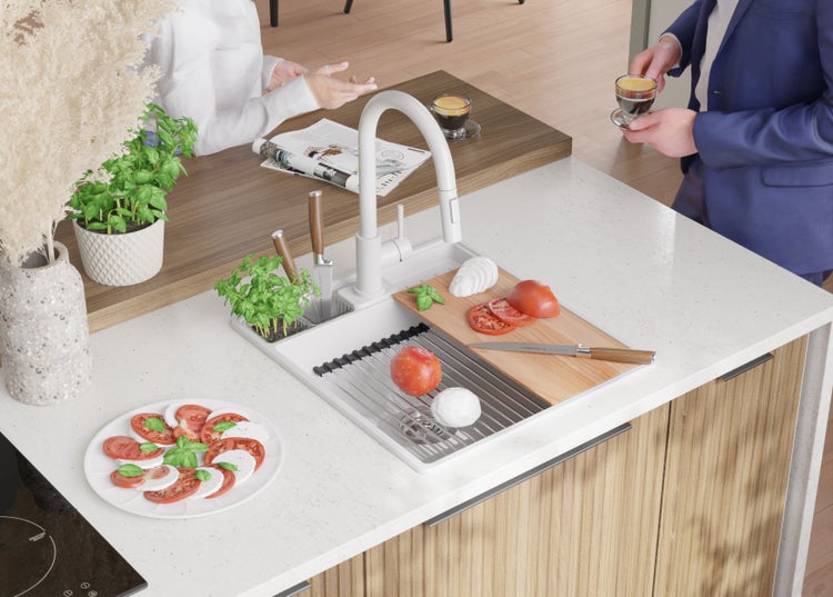 Küchenszene mit Spüle, Armatur, Schneidebrett, Tomaten, Mozzarella, Basilikum und Personen