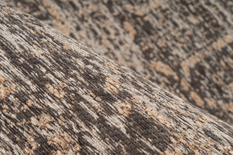 Nahaufnahme einer gewebten Teppichstruktur mit abstraktem, gesprenkeltem Muster und strukturierter Oberfläche.