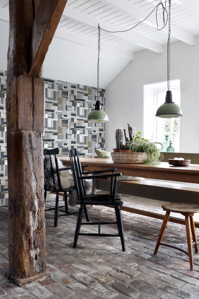 Helles Esszimmer mit Holztisch, Stühlen, rustikalem Holzbalken und geometrischer Tapete