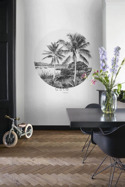 Wohnraum mit Esstisch, Blumen und einer Wand mit einem Palmenmotiv von Esta Home.
