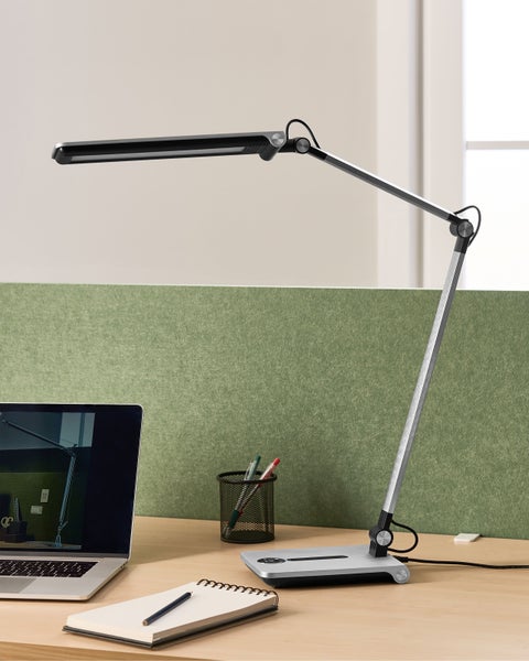 Schreibtisch mit Schreibtischlampe, Notebook und Büromaterial