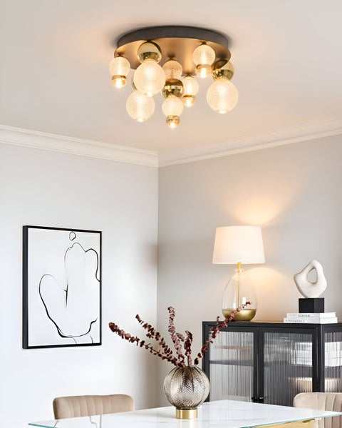 Innenaufnahme eines Esszimmers mit Deckenleuchte mit runden Glasschirmen.