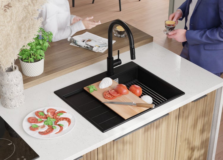 Küchenszene mit schwarzer Spüle, Armatur und Speisen auf einem Schneidebrett